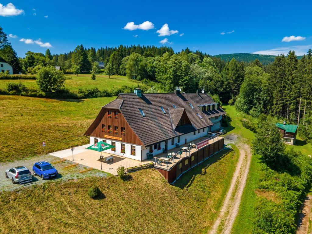 an aerial view of a large house with a car parked at Penzion Pašta in Říčky