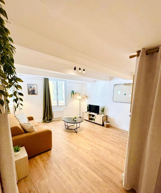 a living room with a couch and a table at Studio neuf en hyper centre, moderne et calme in Toulon