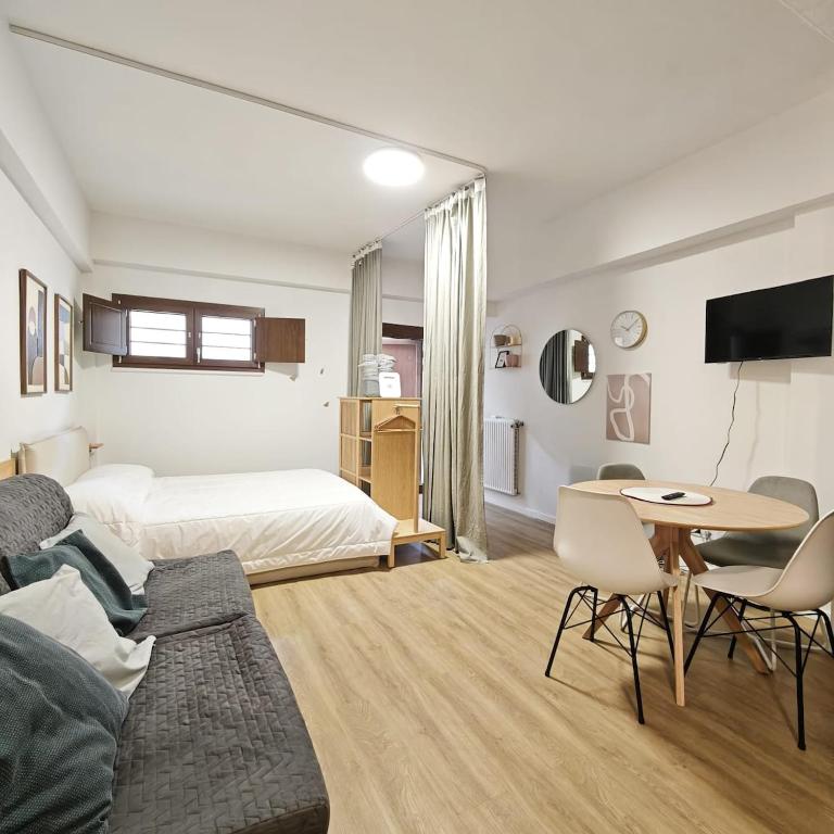 a living room with a bed and a table at RC vacanze interno 57 in Rocca di Mezzo