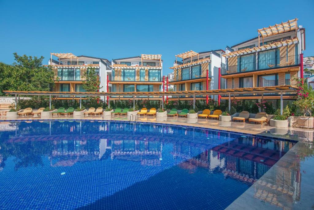 a large swimming pool in front of a building at Asfiya Loft Apartments in Kalkan