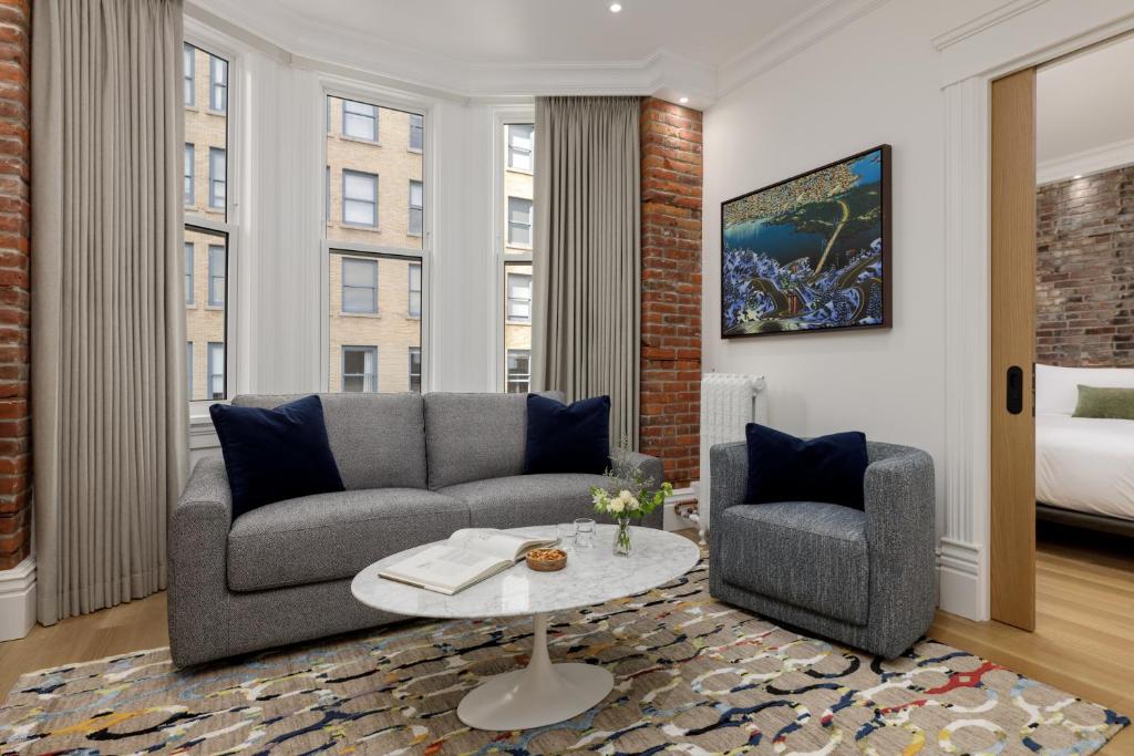 a living room with a couch and a chair at Victorian Hotel in Vancouver