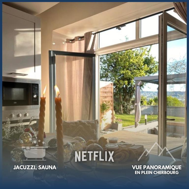 a kitchen with a large window with a view of a yard at L'Envol - Jacuzzi, Sauna et belle vue in Cherbourg en Cotentin