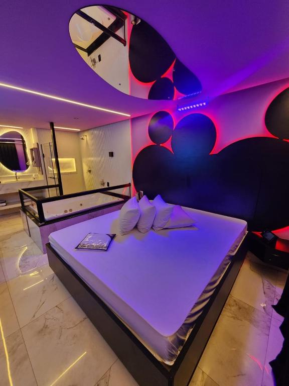 a room with a bed with purple lighting at Fashion Motel in Limeira