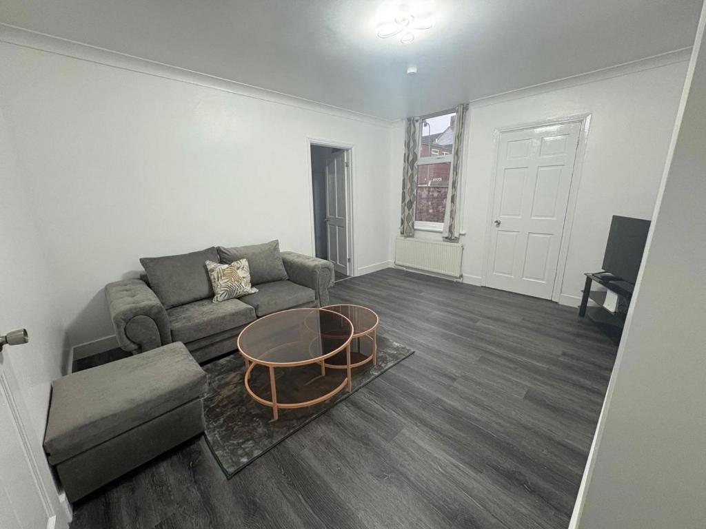 a living room with a couch and a coffee table at 2 Bed Flat - Sleeps 3 - Parking - Wifi in West Boldon