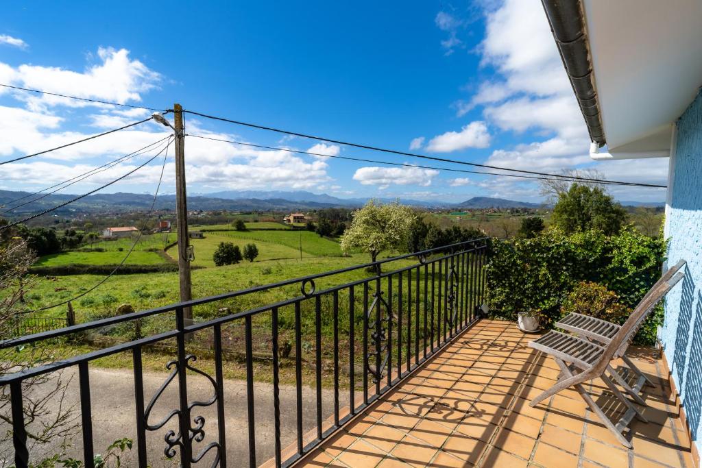 a balcony with a bench and a view at El Caracol azul del Plano in Siero