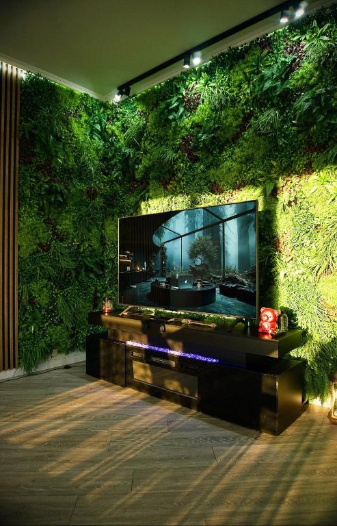 a living wall with a flat screen tv on it at Central Residence Sky Apartment in Rădăuţi
