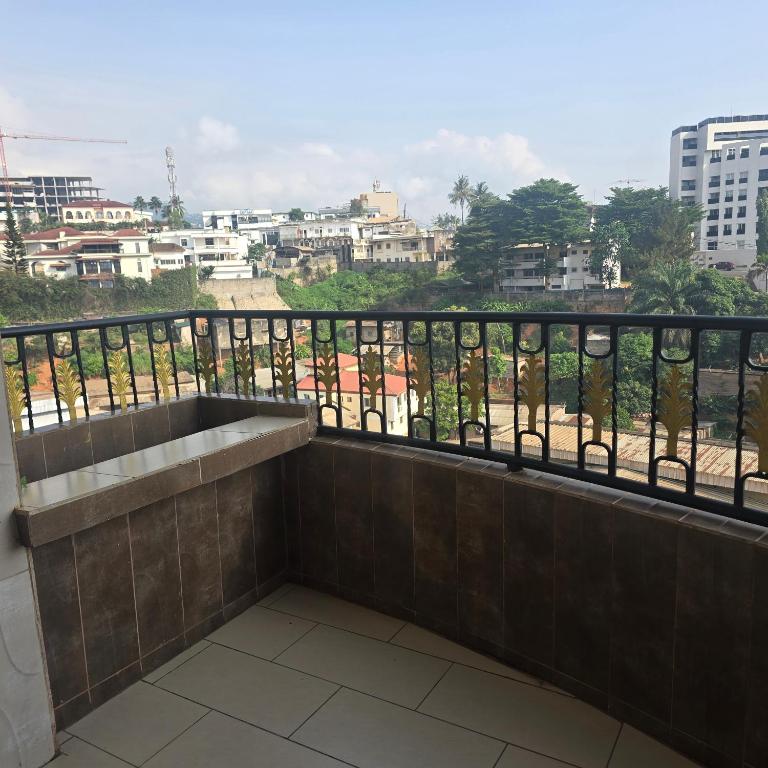 a balcony with a sink and a view of a city at Sweetland Vesidences in Yaoundé