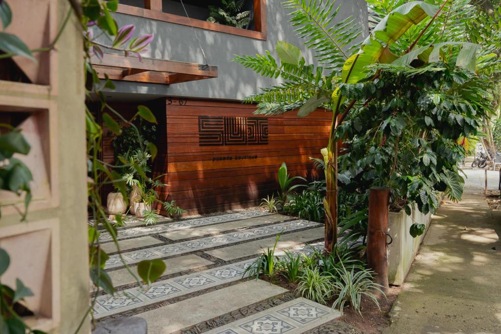 a wooden entrance to a building with plants at Sui Boutique Hotel in Medellín
