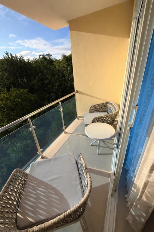 a balcony with two chairs and a table on it at Comforthub Apartment in Higuey