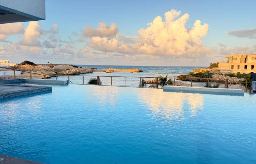 a swimming pool with a view of the ocean at Villa Elegance-3 min Walk to the Beach-20 mins to Ochi Rios in Richmond