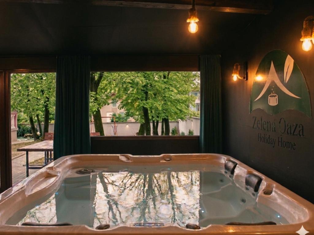 a bath tub in a room with a window at Holiday Home Zelena Oaza in Sarajevo