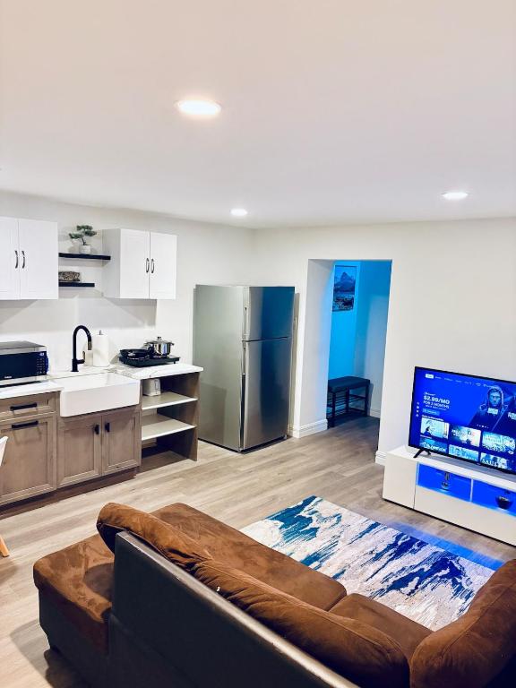 a large living room with a couch and a kitchen at Just Peace Homes in Moncton