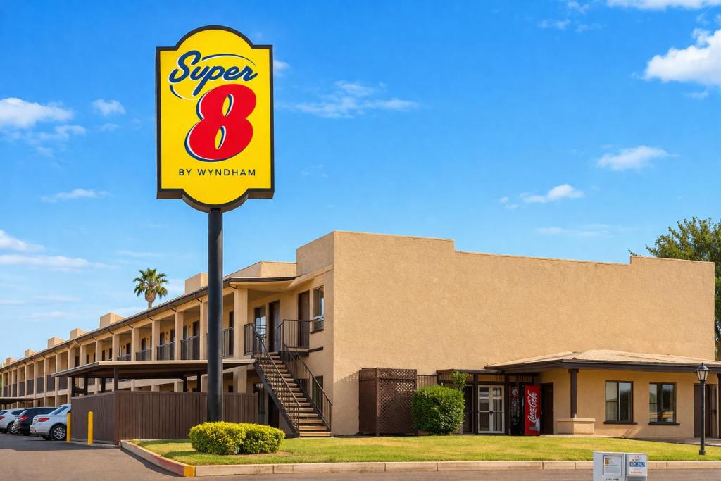 a sign for a super restaurant in front of a building at Super 8 by Wyndham Barstow in Barstow