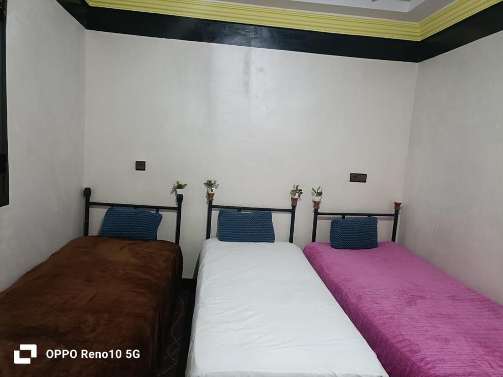 two beds sitting next to each other in a room at Gite souran in Imlil