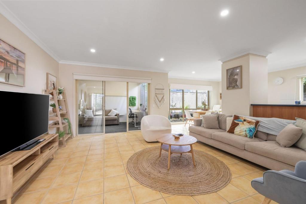 a living room with a couch and a tv at Bay Breeze in Cowes