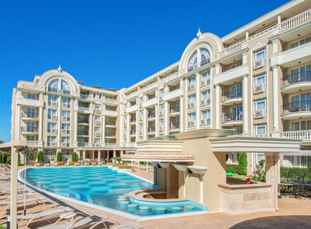 an exterior view of a large building with a swimming pool at Rena Hotel - All Inclusive in Sunny Beach