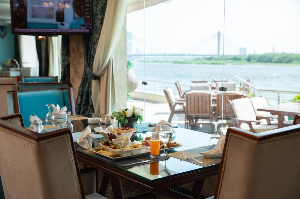 a table with a plate of food on a boat at Nile Trans Hotel in Cairo