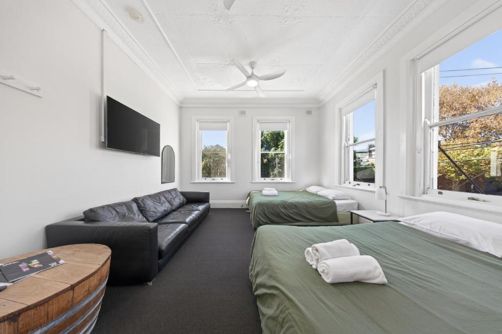 a living room with two beds and a couch at The Oriental Hotel in Newcastle