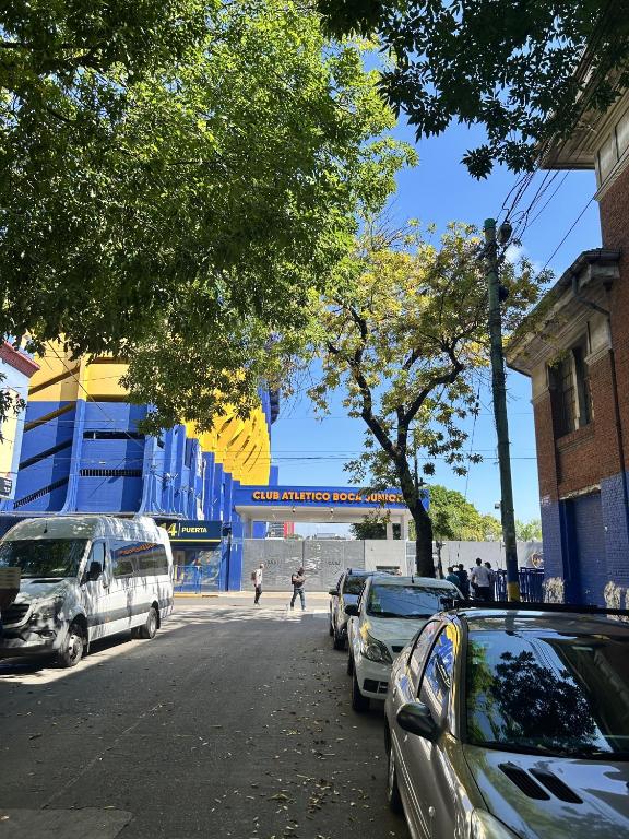 a street with cars parked on the side of the road at Viví el mundo Boca en el HOSTEL DEL 10 in Buenos Aires