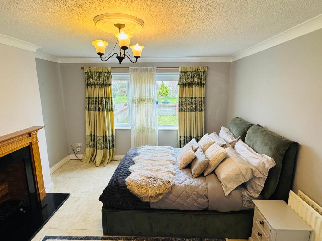 a bedroom with a bed with pillows on it at Lord Windsor's Regal Chamber in Drogheda
