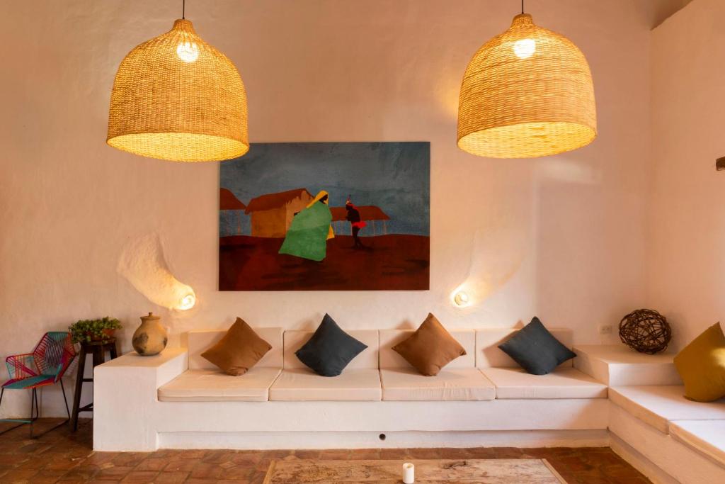 a living room with a white couch and two lights at Romantic Colonial Charm Barichara w Jacuzzi in Barichara