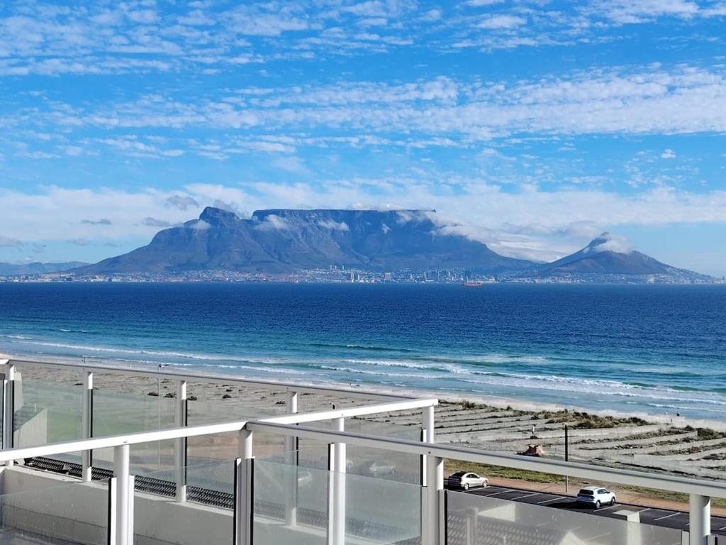 a view of the ocean with a mountain in the background at Atlantic Canvas - Mountain and Sea in Cape Town