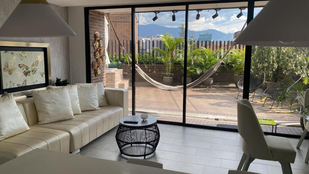 a living room with a couch and a table at Luxury Jacuzzi in Poblado in El Poblado
