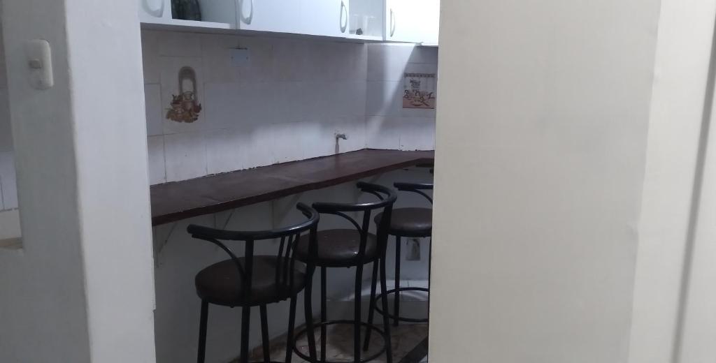 a group of stools at a bar in a kitchen at ChasquiWasi in Lima