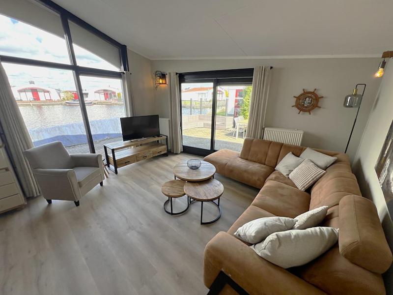 a living room with a couch and a table at Aquaronde 108 in Lemmer