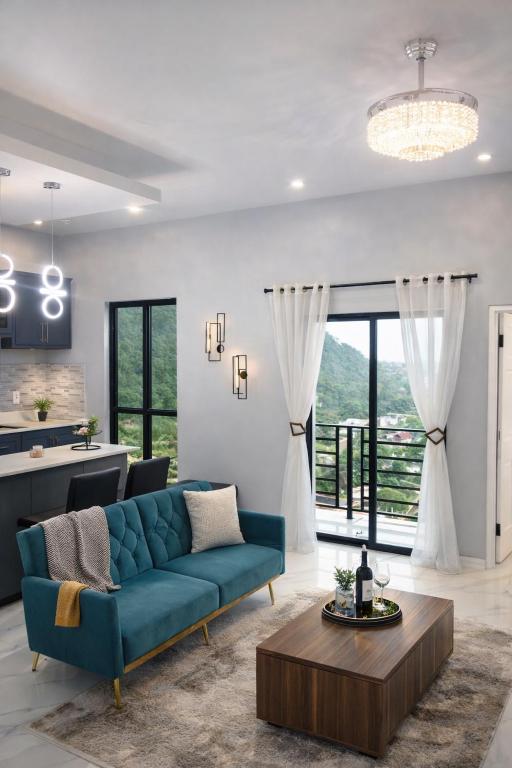 a living room with a blue couch and a table at Hillside Haven in Kingston