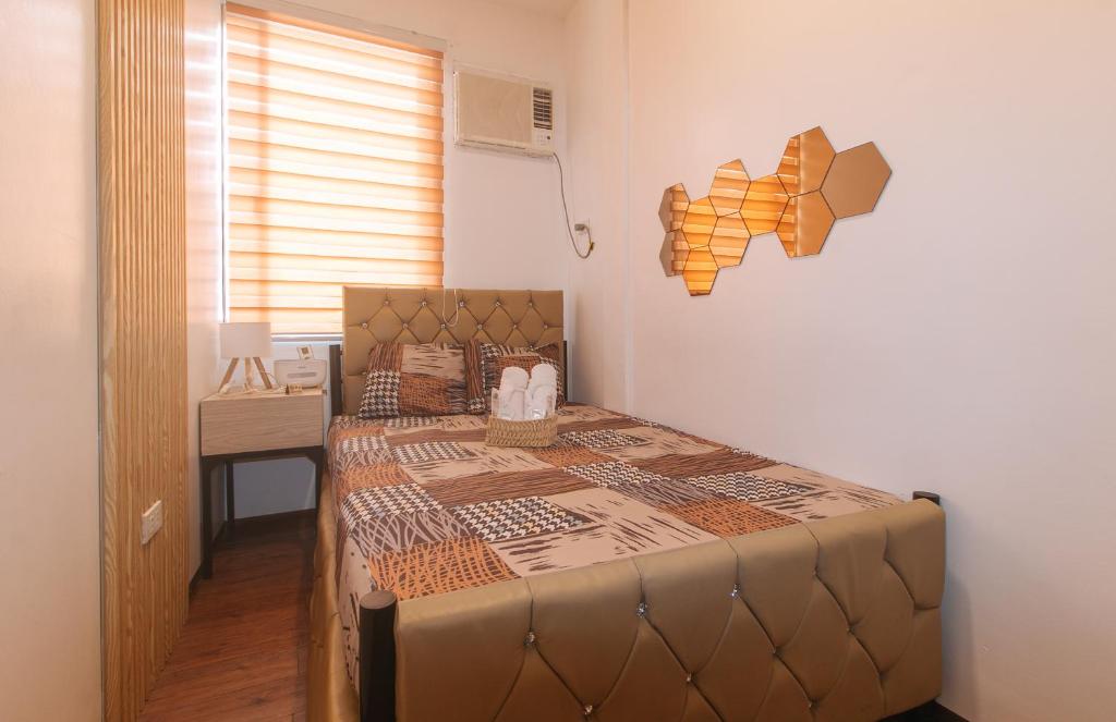 a large bed in a room with a window at G Fam Transient by RedDoorz in Manila