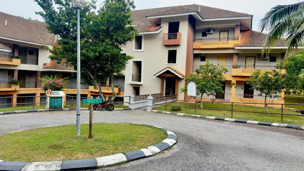 an empty street in front of a large building at Damai Laut Serene Stay Studio Lumut in Lumut