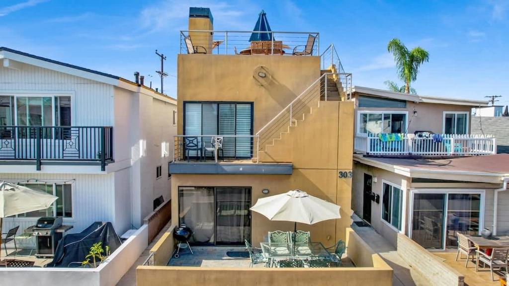 an aerial view of a house with an umbrella at Contemporary Value Duplex with Rooftop Deck- 303 home in Newport Beach