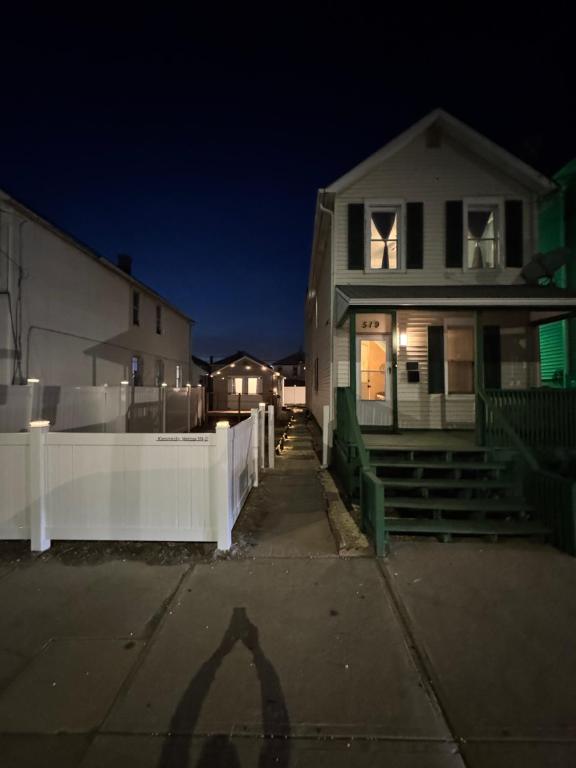 a shadow of a house in front of a white fence at Kennedy Village on Melrose Ave in Atlantic City