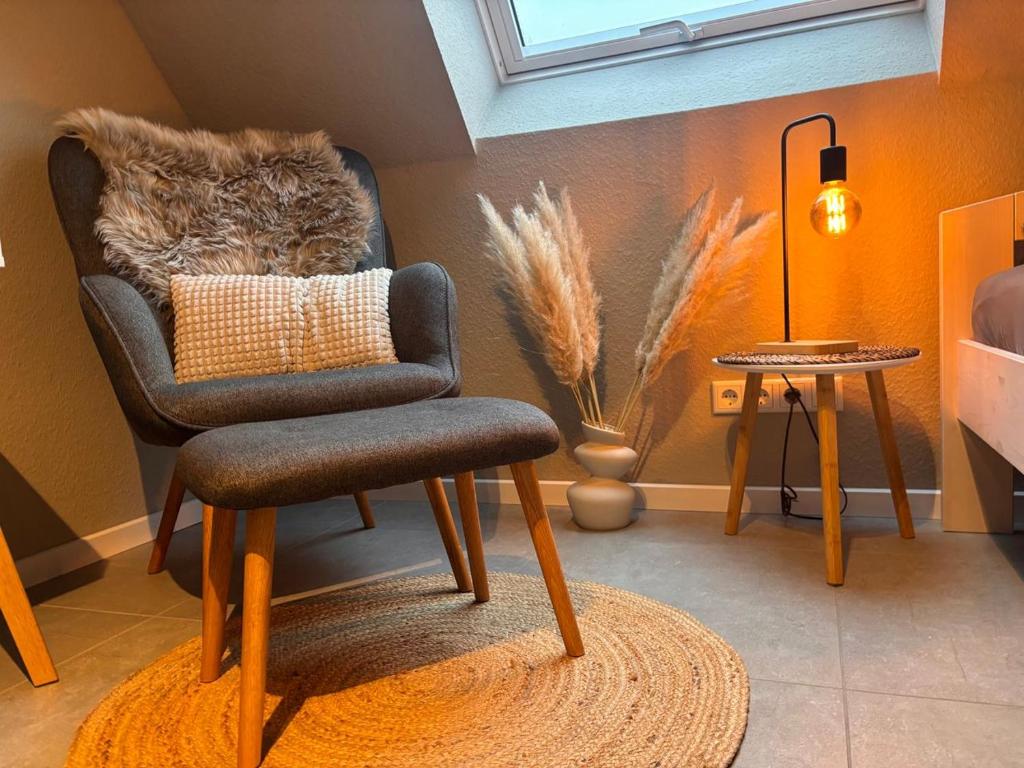 a living room with a chair and a table at Modern Good Location in Hamburg