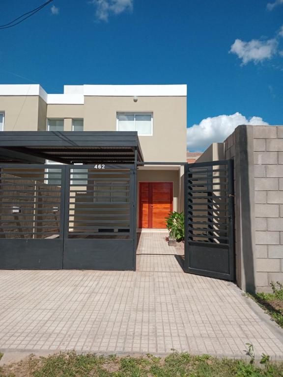 a house with a garage and a red door at Renzo 1 in Deán Funes