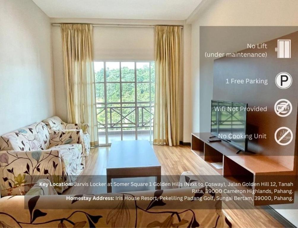 a living room with a couch and a large window at PLAY at Iris Resort Tanah Rata in Cameron Highlands