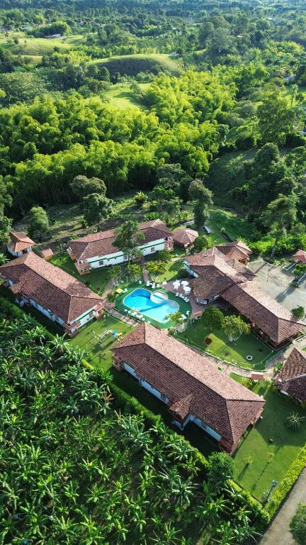 an aerial view of a resort with a pool and trees at Eco Hotel Santa Barbara in Circasia