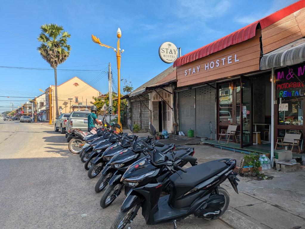 a row of motorcycles parked in front of a street at STAY HOSTEL - MOTORBIKE & LOCKER RENTAL Thakhek in Thakhek