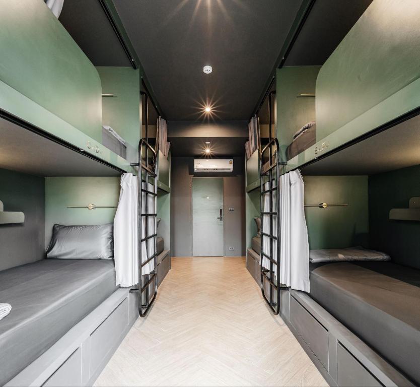 a room with bunk beds and a hallway at Cher Hostel Bangkok in Bangkok
