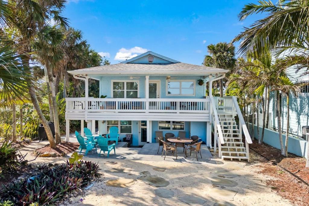 a house on the beach with palm trees at 111 S Atlantic Ave in Cocoa Beach