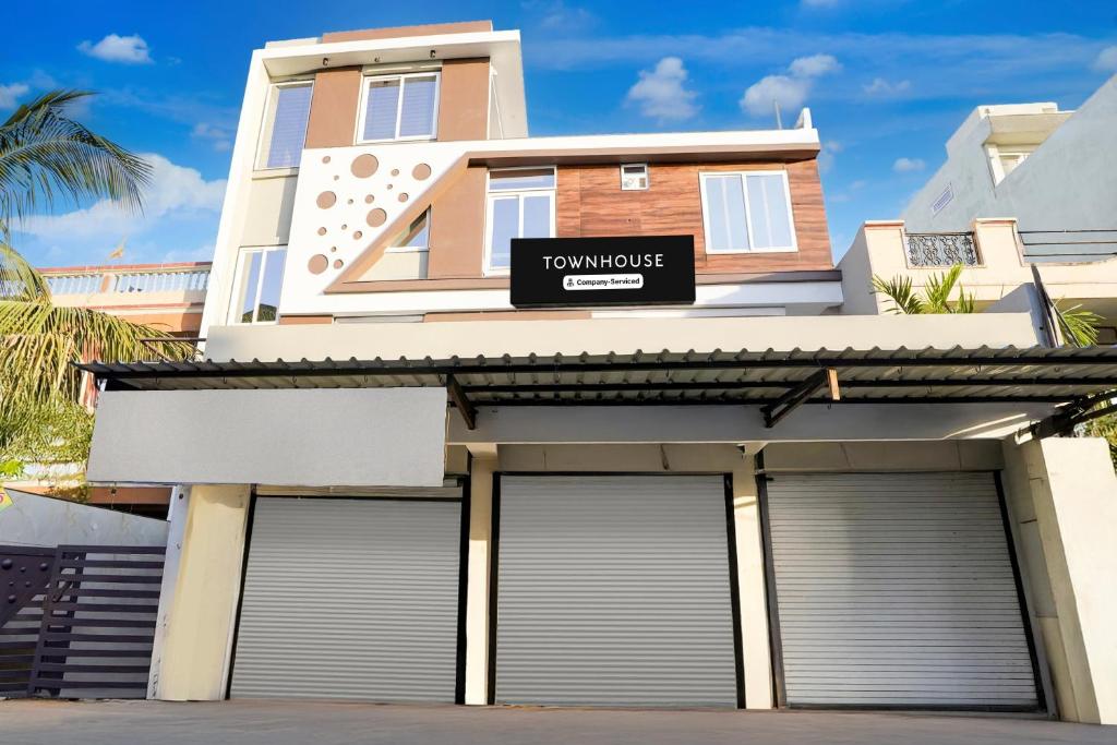 a house with two garage doors in front of it at Super Townhouse Rajendra Nagar Main Road in Indore