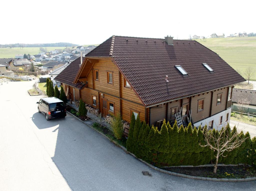 a house with a car parked in front of it at Das Holzhaus in Haidershofen