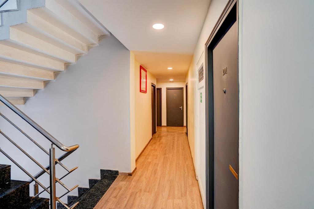 a hallway of a house with a staircase at OYO Townhouse Singapore Mall Formerly Hotel Sunshine in Lucknow