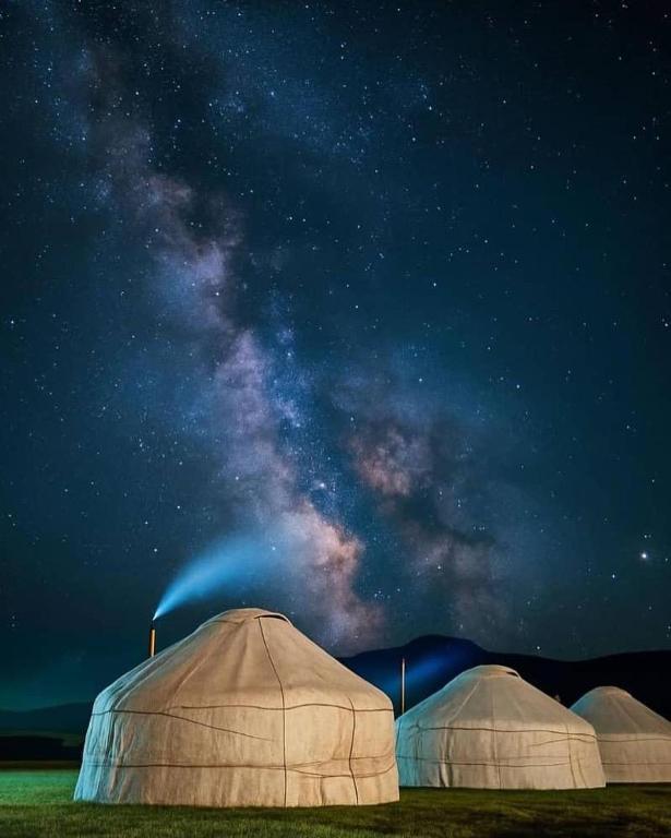 three domes in a field under a starry sky at NOMAD KEL-SUU Yurt Camp in Kol-Suu