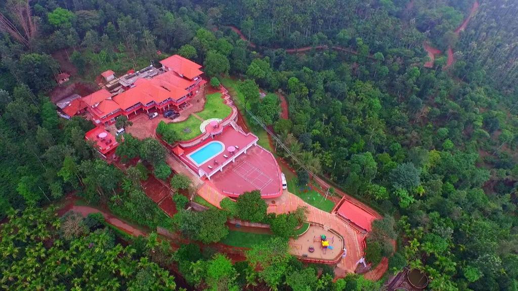 an aerial view of a large house with a pool at Upasana Retreat in Kalasa