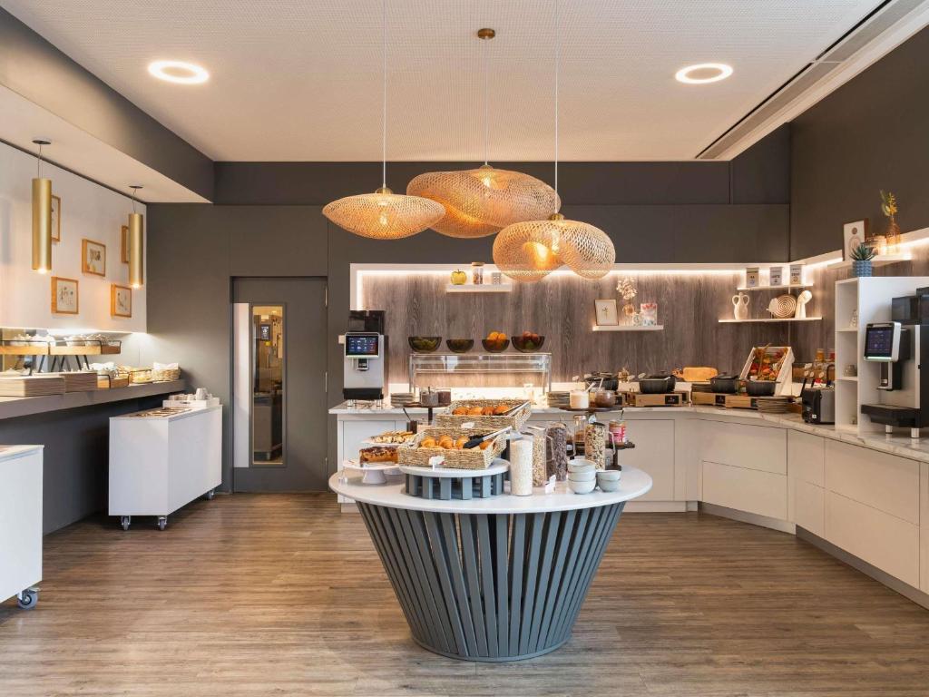 a kitchen with a counter with food on it at Novotel Suites Luxembourg in Luxembourg