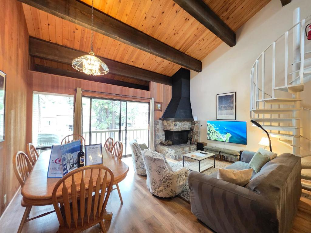 a living room with a table and a fireplace at Spiral Staircase home in Kings Beach