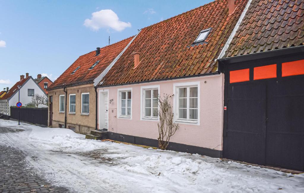 a row of houses on a snow covered street at 3 Bedroom Nice Home In Simrishamn in Simrishamn