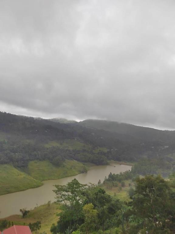 a river in the middle of a field with trees at Smart heritage in Galaha Town